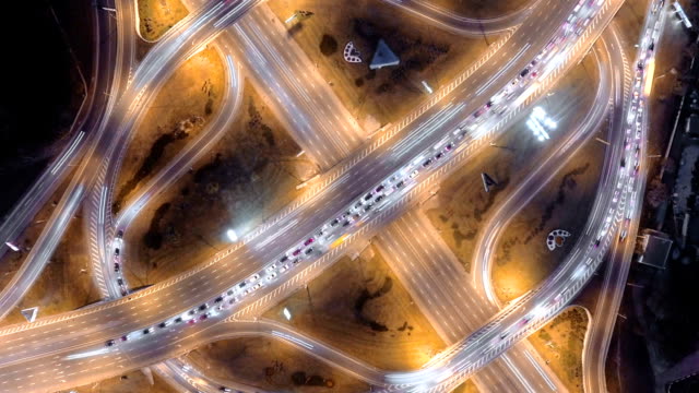 Hyperlapse-timelapse-of-night-city-traffic.-vertical-aerial-view.