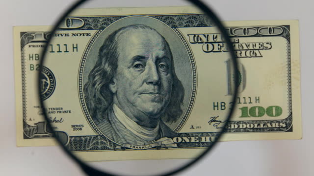 Approaching-using-a-magnifying-glass-hundred-dollar-bill