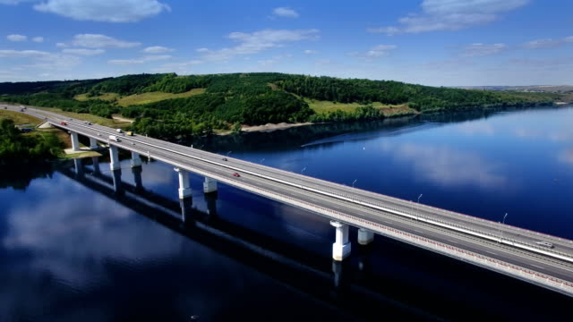 AERIAL-Fly-over-traffic-bridge-highway-roadway-road-way-and-blue-river-with-trees-forest,-Europe,-Russia,-Tatarstan