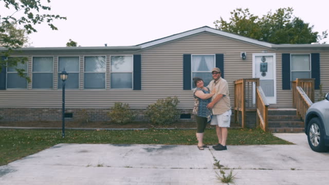 Happy-heavy-couple-hugging-in-front-of-a-manufactured-home