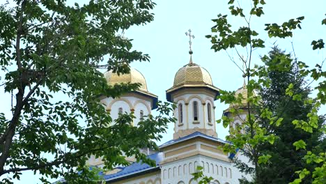 Orthodox-church,-Catholic-church,-dome-of-a-church-against-a-blue-sky,-Against-the-skyGolden-domes