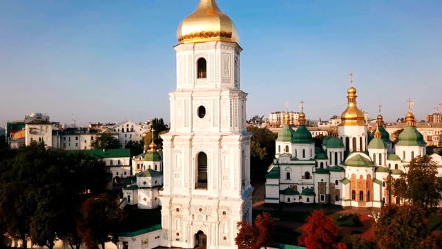 Saint-Sophia's-Cathedral,-square.-Kiev-Kiyv-Ukraine-with-Places-of-Interest.-Aerial-drone-video-footage.-Sunrise-light.-City-panarama.-the-camera-moves-away-from-the-building