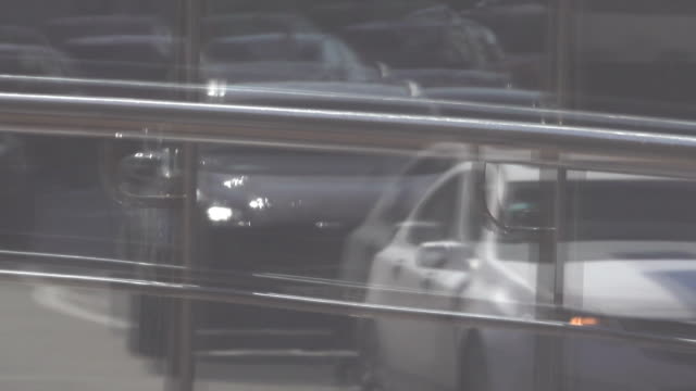 Reflection-in-the-showcase-of-car-traffic