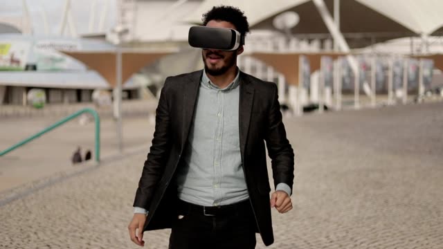 Young-middle-eastern-man-wearing-formal-suit-with-VR-glasses.