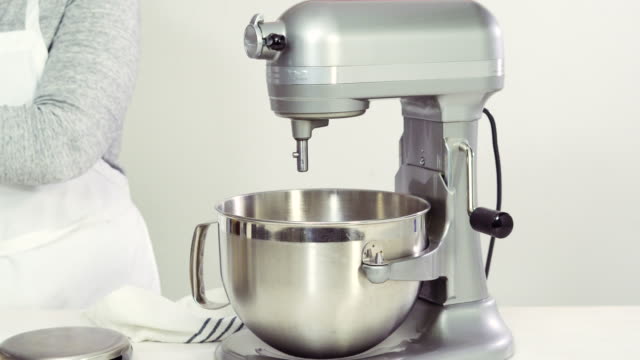 Mixing-royal-icing-in-electric-kitchen-mixer-for-Easter-cookies.