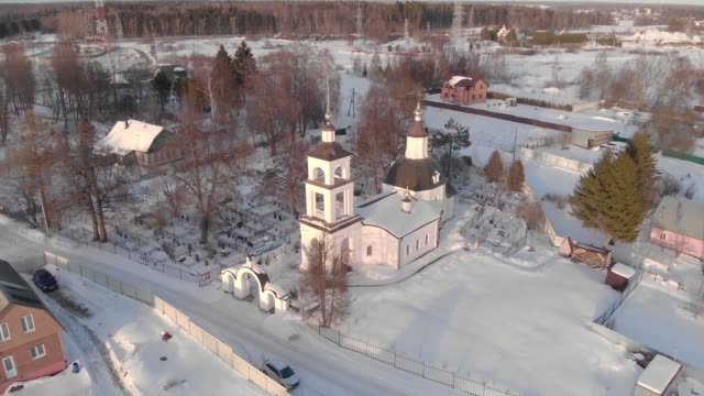 Flying-in-winter-over-the-church-in-clear-weather-at-dawn-from-altitude