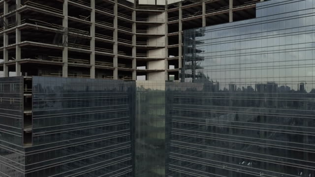 Unfinished-skyscraper-with-a-glass-facade.-The-camera-moves-up.-Aerial-view