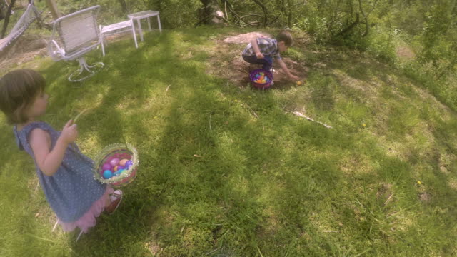 POV-of-a-parent-following-their-two-young-children-on-a-Easter-egg-hunt