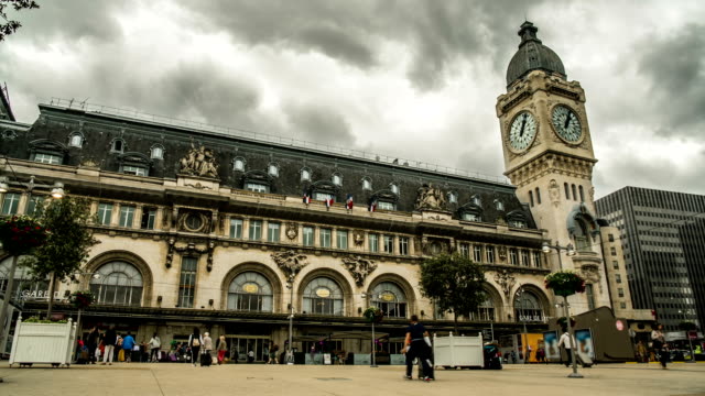 People-walking-across-square-in-front-of-entrances-to-Lyon-railway-terminal