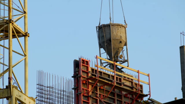 Crane-carrying-concrete-for-pouring-walls-and-partitions-at-housing-estate