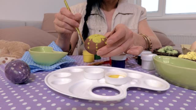 Woman-hands-painting-Easter-eggs