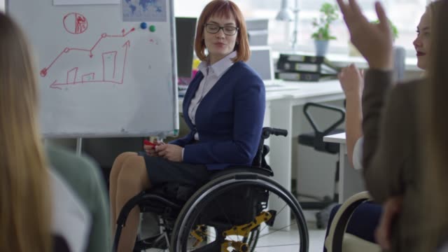 Female-Manager-in-Wheelchair-Leading-Business-Seminar