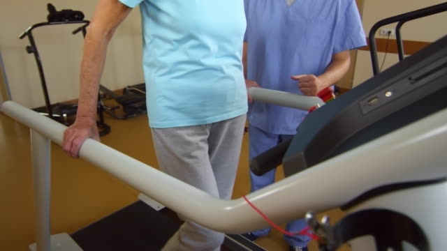 Ältere-Frau,-die-Ausübung-auf-Laufband-während-der-Physiotherapie-Sitzung