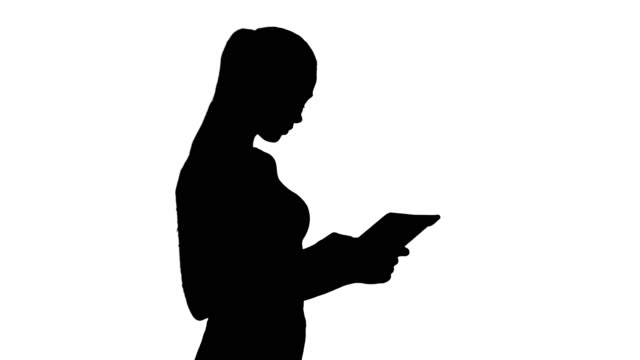 Silhouette-Beautiful-young-adult-womann-having-fun-playing-game-with-tablet