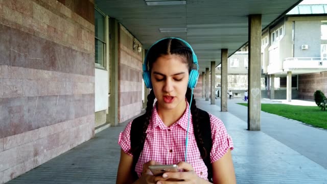 Girl-listening-music-from-smart-phone-mp3-player