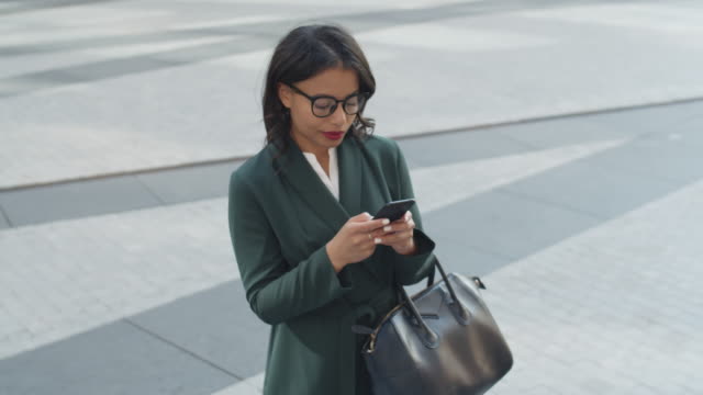 Businesswoman-Using-Mobile-Phone-Outdoors