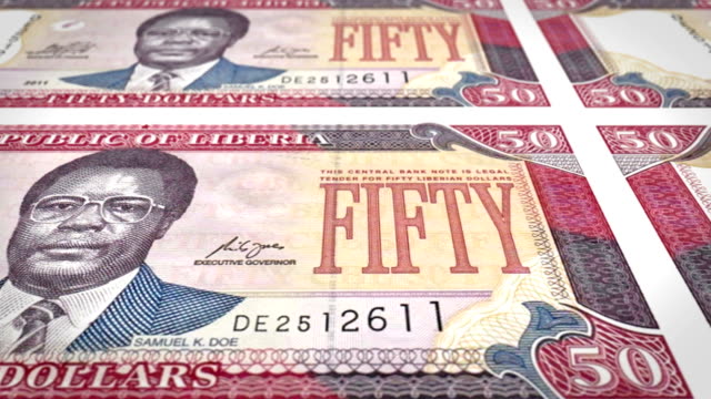 Banknotes-of-fifty-dollars-of-the-bank-of-Liberia-rolling-on-screen,-coins-of-the-world,-cash-money,-loop