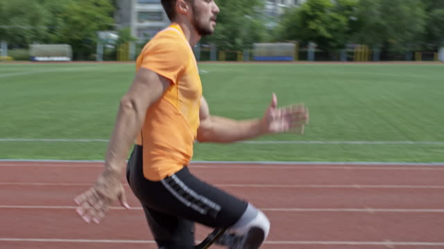 Professional-Runner-with-Artificial-Leg-Jogging-on-Stadium