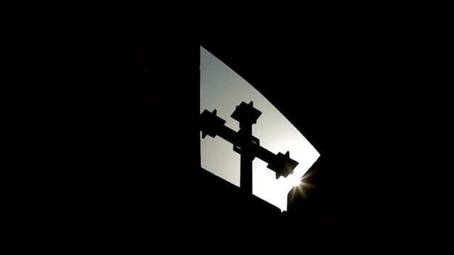 Sunlight-streaming-through-window-into-church,-cross-silhouette,-feeling-hope