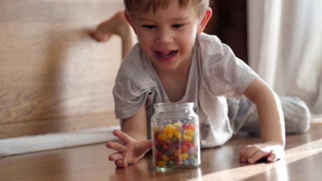 cute-boy-catching-jar-of-candies