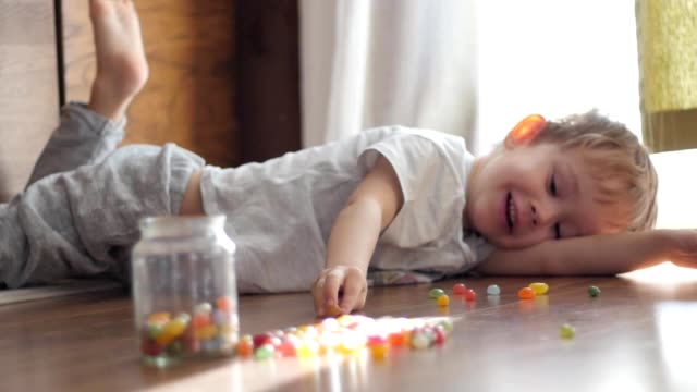 cute-boy-playing-with-colorful-candies
