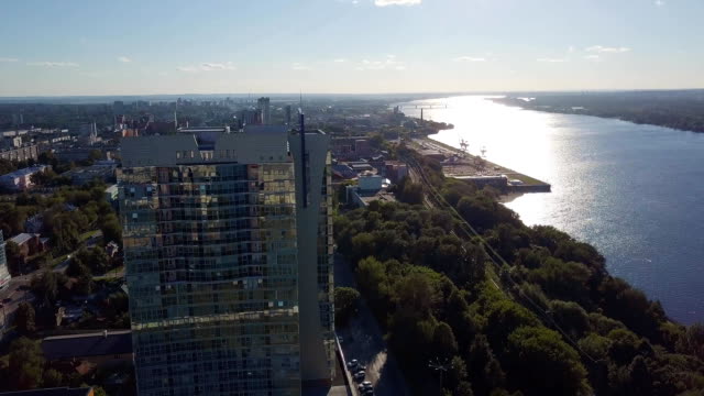 Cityscape-in-day-time-nearly-evening-time.-Clip.-Top-view-of-the-tall-building-near-the-river-on-a-Sunny-day