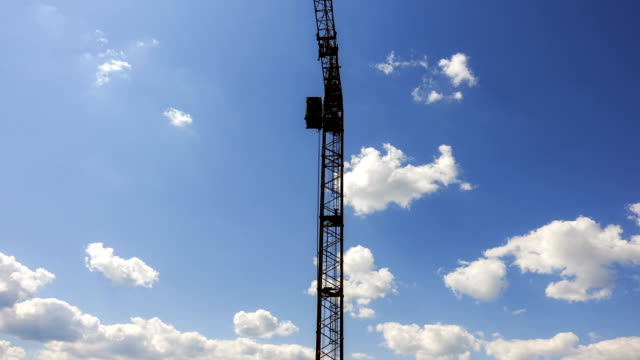Timelapse-footage-of-a-construction-crane,-blue-sky