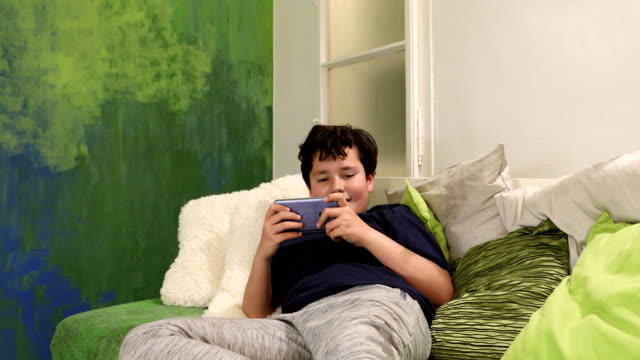 Portrait-of-a-young-boy-paying-video-games-at-home