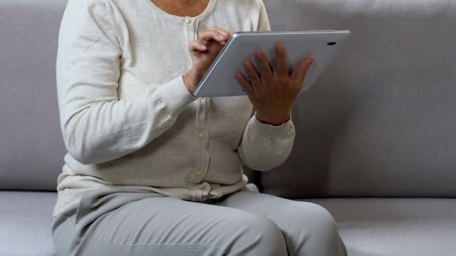 Middle-aged-woman-surfing-web-on-tablet,-shopping-online,-searching-discount
