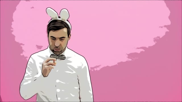 Young-man-standing-on-a-pink-background.-With-a-rabbit-ears.-Carrots-are-put-in-the-mouth-and-set-fire-to-the-ashtray.-Easter.