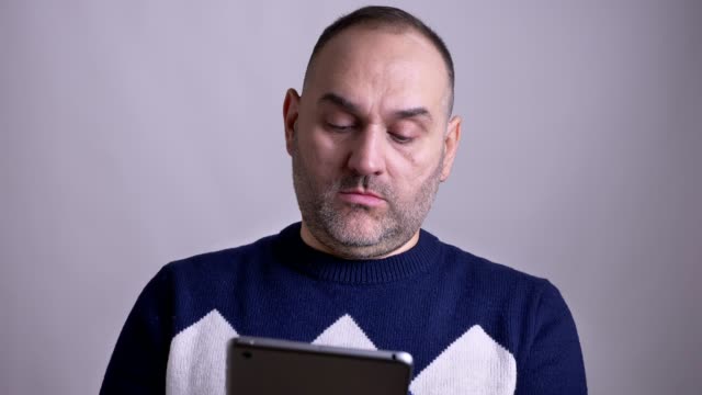 Nahaufnahme-Porträt-von-erwachsenen-kaukasischen-Mann-mit-dem-Tablet-dann-mit-Blick-auf-Kamera-und-lächelnd