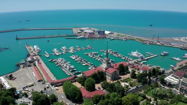 Aerial-video-shooting.-Panoramic-view-of-the-sea-port-of-Sochi,-Russia.-Luxury-yachts-and-boats-are-in-the-Bay.-The-view-from-the-top.-City-attraction.-Black-Sea.