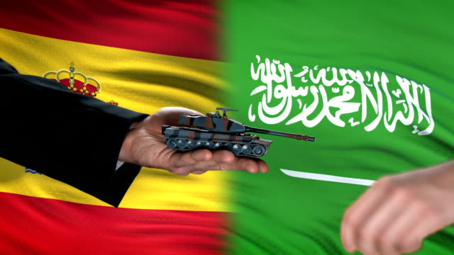 Spain-and-Saudi-Arabia-officials-exchanging-tank-for-money,-flag-background