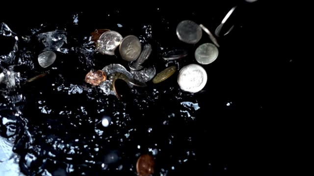 Coins-fall-in-water.-Slow-motion.