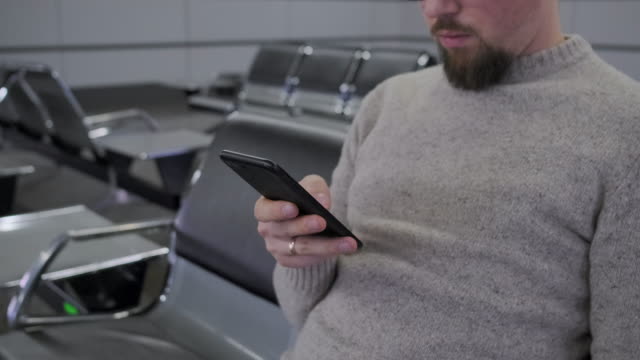 Man-is-typing-on-display-of-mobile-phone