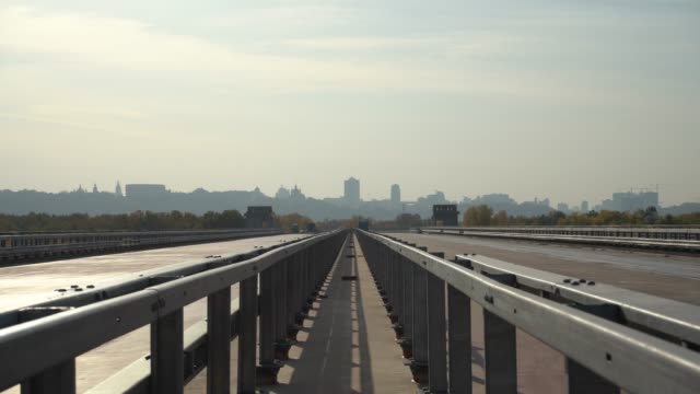Unfinished-bridge-against-the-background-of-the-silhouette-of-the-city.-Unfinished-highway-away-city