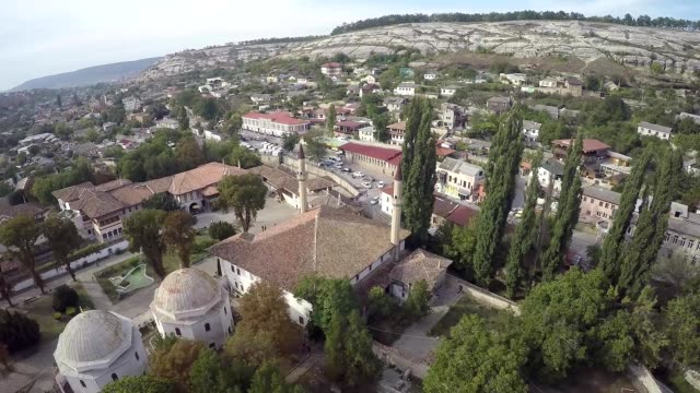 Aerial-view-on-the-old-city-with-church-before-sunset,-sunrise.-Fog,-Cloudy-sky.-Bahchisarai,-Crimea,-Russia.
