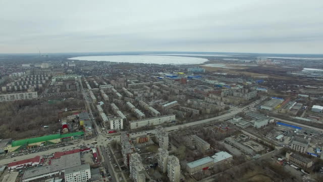 Aerial-survey-on-city.-View-from-the-sky-on-Russian-city.-Aerial-city-view-on-houses,-streets-and-parks.-Grey-sky-and-garages-really-residential-district.-Aerial-survey-on-the-street-where-drive-a-lot-of-car.Chelyabinsk.-Ural.-Overhead-Aerial-Flight-Over