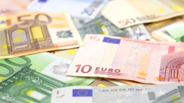 Approaching-close-up-dolly-shot-of-scattered-European-paper-money.-Dolly-shot.