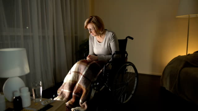 Upset-lady-in-wheelchair-thinking-about-children,-abandoned-patient-nursing-home