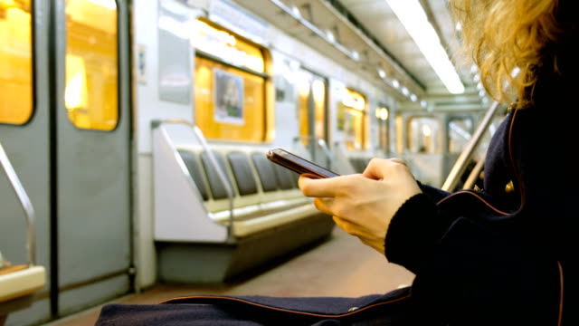 Frau-nutzt-eine-Smartphone-in-der-u-Bahn-Nahaufnahme