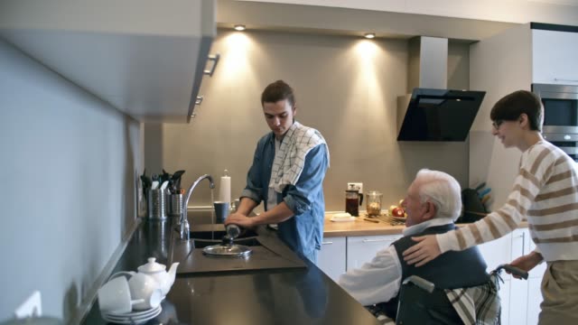 Social-Worker-Helping-Elderly-Man-with-Housework