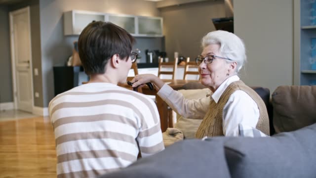 Cheerful-Woman-Chatting-with-Elderly-Lady