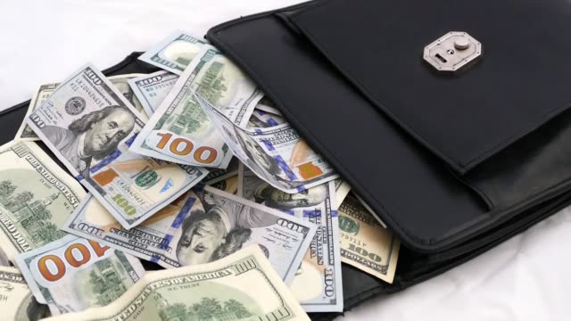 black-money-bag-full-of-dollars,-bags-and-many-100-usd-banknotes,