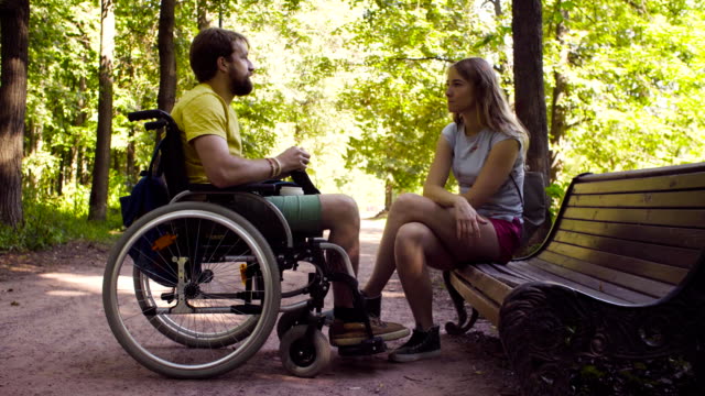Young-disable-man-with-his-wife-on-a-walk-in-the-park