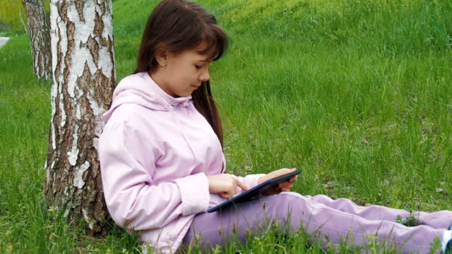 A-child-with-a-tablet-on-the-nature.