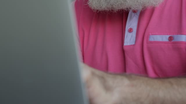 Senior-bearded-man-uses-laptop--in-cafe