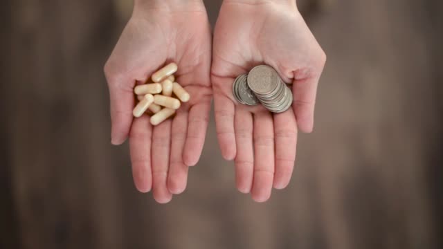 Folding-palms-hold-pills-and-coins.
