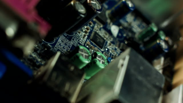 Closeup-on-electronic-board-in-hardware-repair-shop,-blurred-and-toned-image.-Shallow-DOF,-focus-on-the-middle-left-field