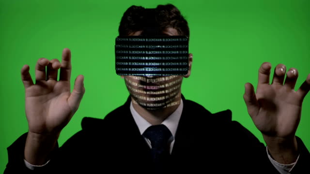 Male-engineer-dressed-in-suit-and-tie-using-futuristic-virtual-reality-technology-to-type-and-check-blockchain-data-on-green-screen